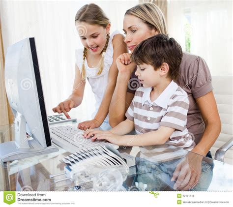 Mother Teaching Her Children How To Use A Computer Royalty