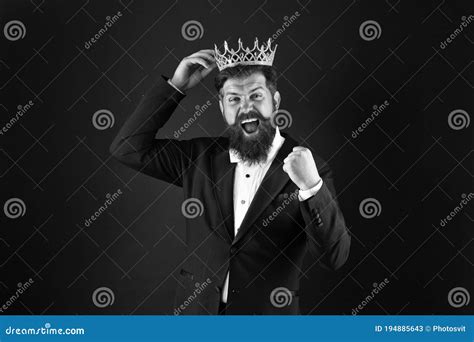 Handsome King With Goatee Stands On Stone Balcony With Sword And Crown