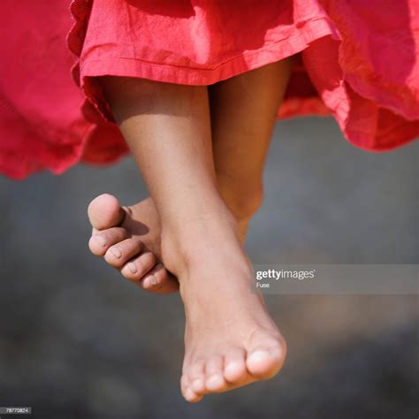 Barefoot Girl Sitting On Swing Photo Getty Images