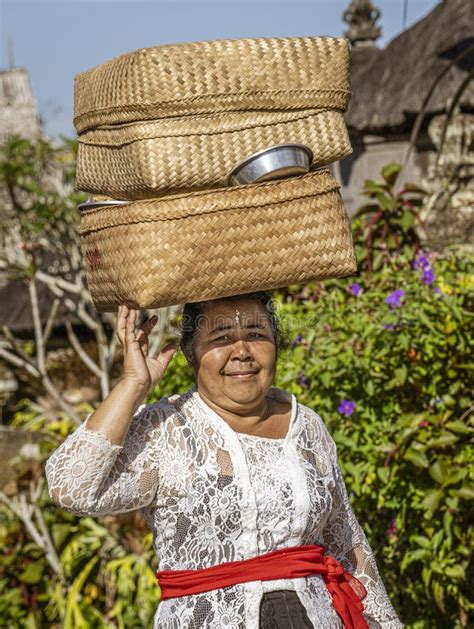 bali indonesia june 1 2022 woman carries basket on her head as she walks editorial image