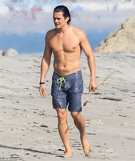 Orlando Bloom Reveals Chiseled Pecs And Toned Abs As He Strips To His Shorts For Day On The