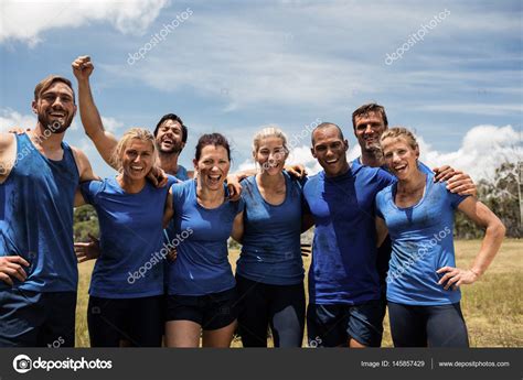 Group Of Fit People Posing Together In Boot Camp Stock Photo By