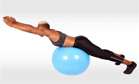 Fit Woman Doing Back Extensions Exercise On Swiss Ball