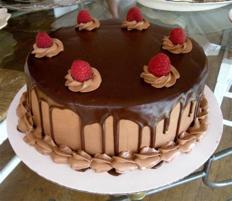 Year after year chocolate cake is rated the most popular by people all over the world. Dark chocolate cake with raspberry filling, chocolate Swiss meringue buttercream, and raspberry ...