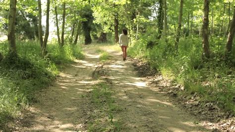 Sexy Woman Walking On A Countryside Road Tracking Shot Stock Footage
