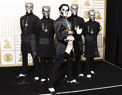 the metal band ghost hold up their award for best metal performance for cirice grammys 2016