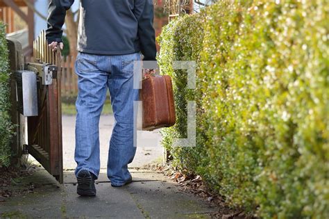 Man leaving home with a suitcase for a journey — Photo — Lightstock