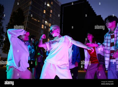 Drive In Motion Stylish People Dancing Hip Hop In Bright Clothes On City Background At Dance