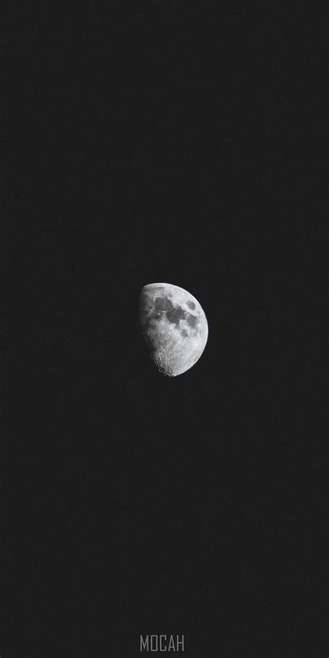 282357 Dark Spots Visible On A Half Moon Against A Black Night Sky