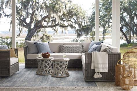 An Outdoor Living Room With Wicker Furniture