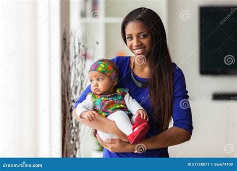 Young African American Mother Holding With Her Baby Girl Stock Photo