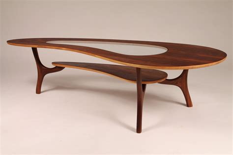 The desk has three drawers and a writing shelf, the desk is very uniquely designed. 1960 WALNUT COFFEE TABLE (veneer) kidney shaped with ...