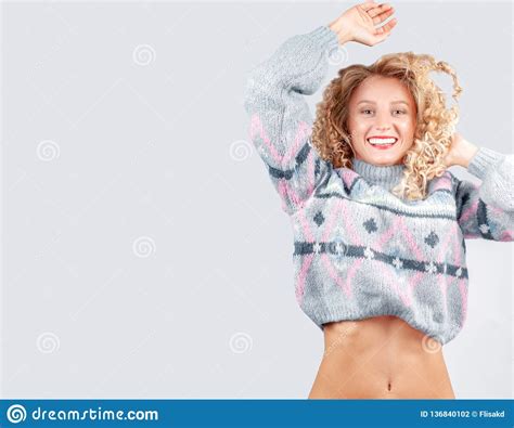 Attraktive Studentenfrau Mit Dem Gelockten Haar Gekleidet In Der Warmen Strickjacke Stockfoto