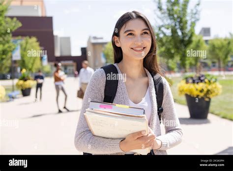 Portrait Happy Female College Student On Sunny Campus Stock Photo Alamy