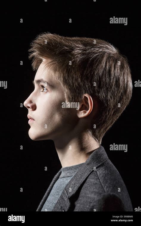 Profile Shot Of Teenage Boy Over Black Background Stock Photo Alamy