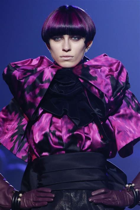 A Woman With Purple Hair And Black Gloves On The Catwalk At A Fashion Show