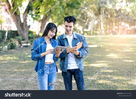 Asian Student Couple Studying Outside On Stock Photo 1931371442