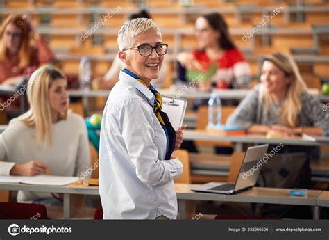 Female Elderly Professor Giving Lecture Answering Questions Stock Photo