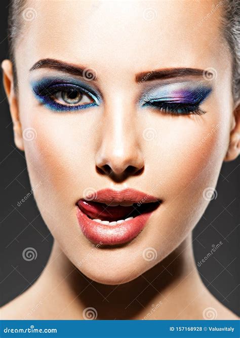Beautiful Face Of An Young Woman With Blue Makeup Of Eyes Stock Photo