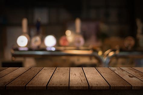 Wooden Table With A View Of Blurred Beverages Bar Backdrop Stock Photo