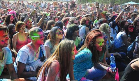 Young People Covered In Coloured Powder Are Dancing And Singing On