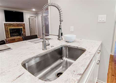 Finished and unfinished kitchen cabinets. Stainless Steel Kitchen Prep Sink and White Countertops | HGTV