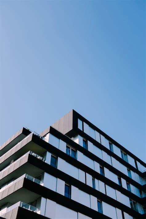 White And Black Concrete Building Under Blue Sky · Free Stock Photo