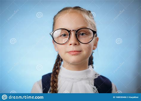Cute Little Schoolgirl Wearing Glasses On Blue Backround