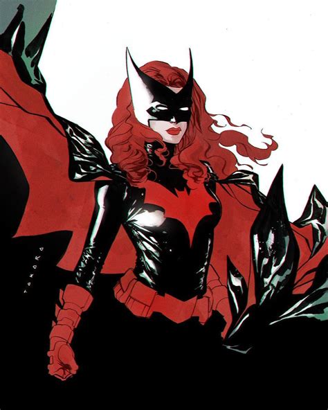 A Woman Dressed In Black And Red Standing Next To A Bat