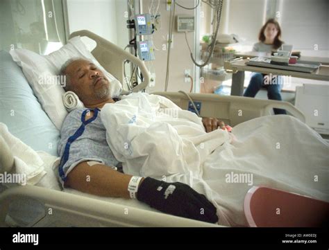 A Black Man Lies In A Hospital Intensive Care Unit Icu Recovering