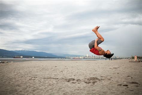 Man Doing Back Flip At Beach Photograph By Christopher Kimmel Fine Art America