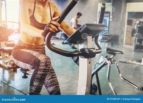 Fitness Woman Working Out On Exercise Bike At The Gym Stock Image