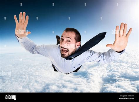 Terrified Businessman Falling From The Sky Stock Photo Alamy