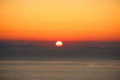 Free Stock Photo Of Sunset Behind Land On Ocean