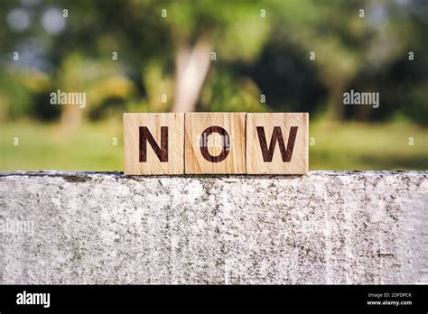 Wooden Block With The Word Now Stock Photo Alamy