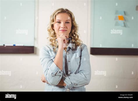 Portrait Of Beautiful Confident Woman Standing In Office Stock Photo
