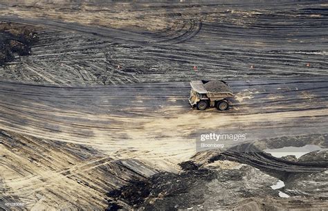 A Truck Drives Through The Syncrude Canada Ltd Mine In This Aerial