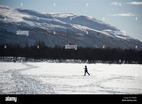 Cross Country Skiing Across A Frozen Lake In Tromso