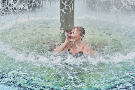 mature woman under jets of water outdoor thermal pool stock image image of retired health