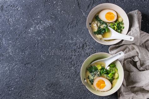 While i borrowed the egg and lemon motif, i also added spinach used orzo instead of the rice. Asian Soup With Eggs, Onion And Spinach Stock Photo ...