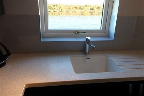 Glass Splashback And Window Sill Fitted Behind Sink Looking Over Lake