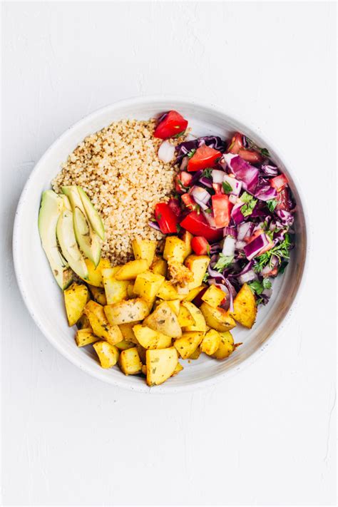 Vegan Buddha Bowl With Turmeric Infused Roasted Potatoes And Quinoa