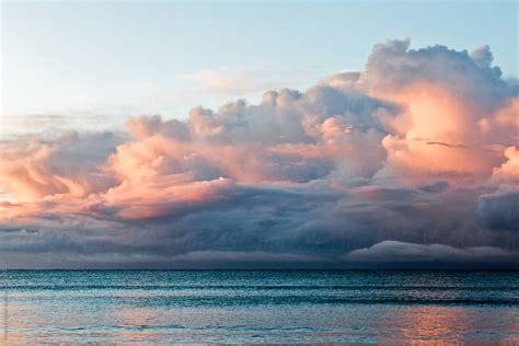 Storm Clouds Developing At Sunrise Over Ocean By Stocksy Contributor