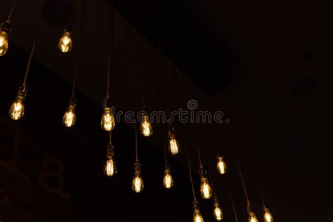 Glowing Light Bulbs Hanging On Black Background Stock Photo Image Of