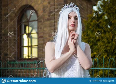 Sensual Relaxed Caucasian Bride With Tiara And Long White Hair Posing
