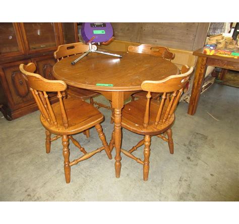 Glass table with iron matching chairs. Used round wood dining table with 4 chairs