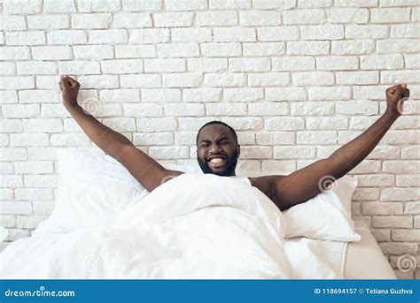 Black Awakened Man Is Stretched Out In Bed Stock Image Image Of