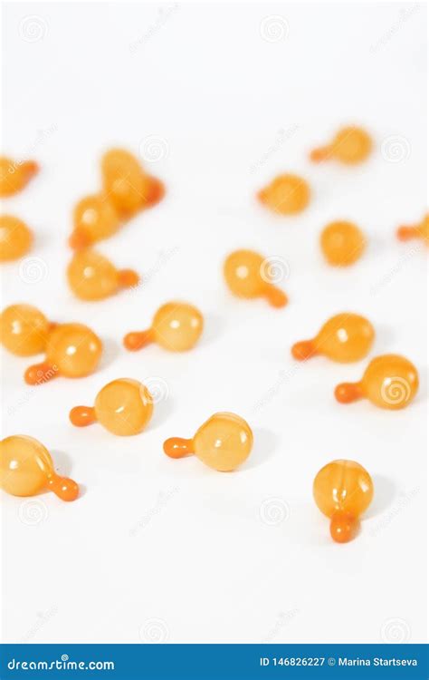 Orange Medical Capsules With Oil Or Medicine On A White Background