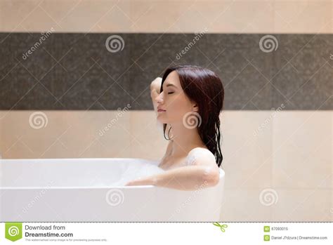 Beautiful Brunette Woman Relaxing In Bathtub Stock Image
