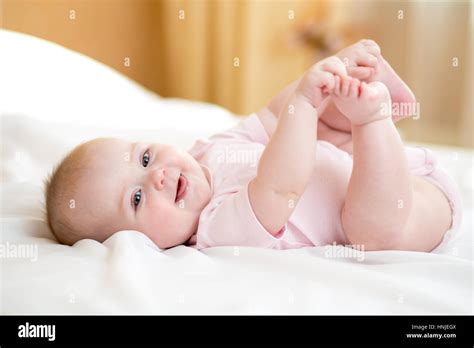 Funny Chubby Baby Infant Girl Playing With Feet Stock Photo Alamy